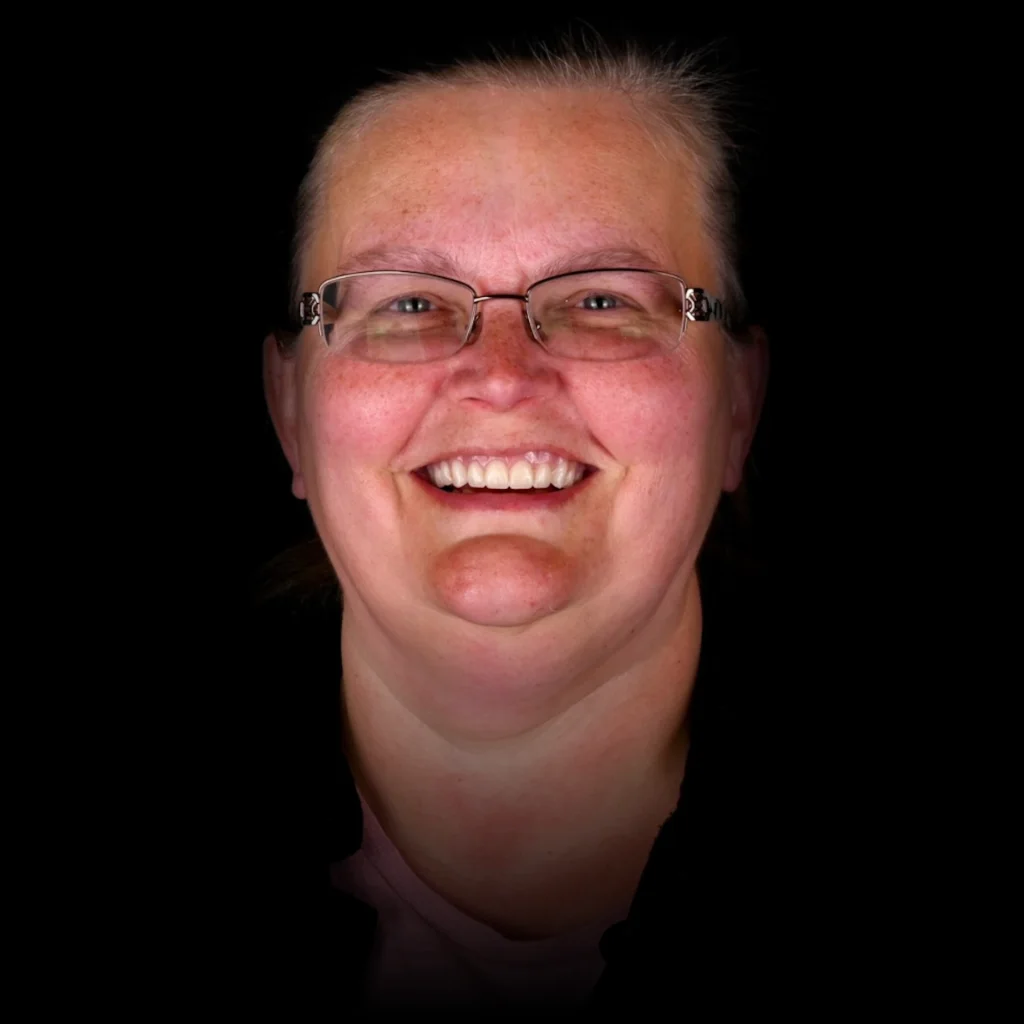 Patient smiling after all on 4 dental implants at PRACTICENAME