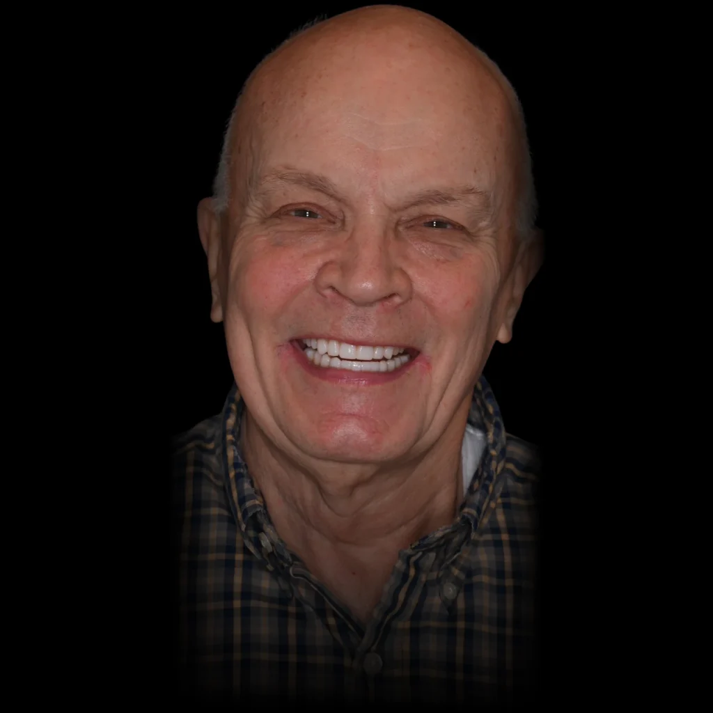 Patient smiling after all on 4 dental implants at PRACTICENAME