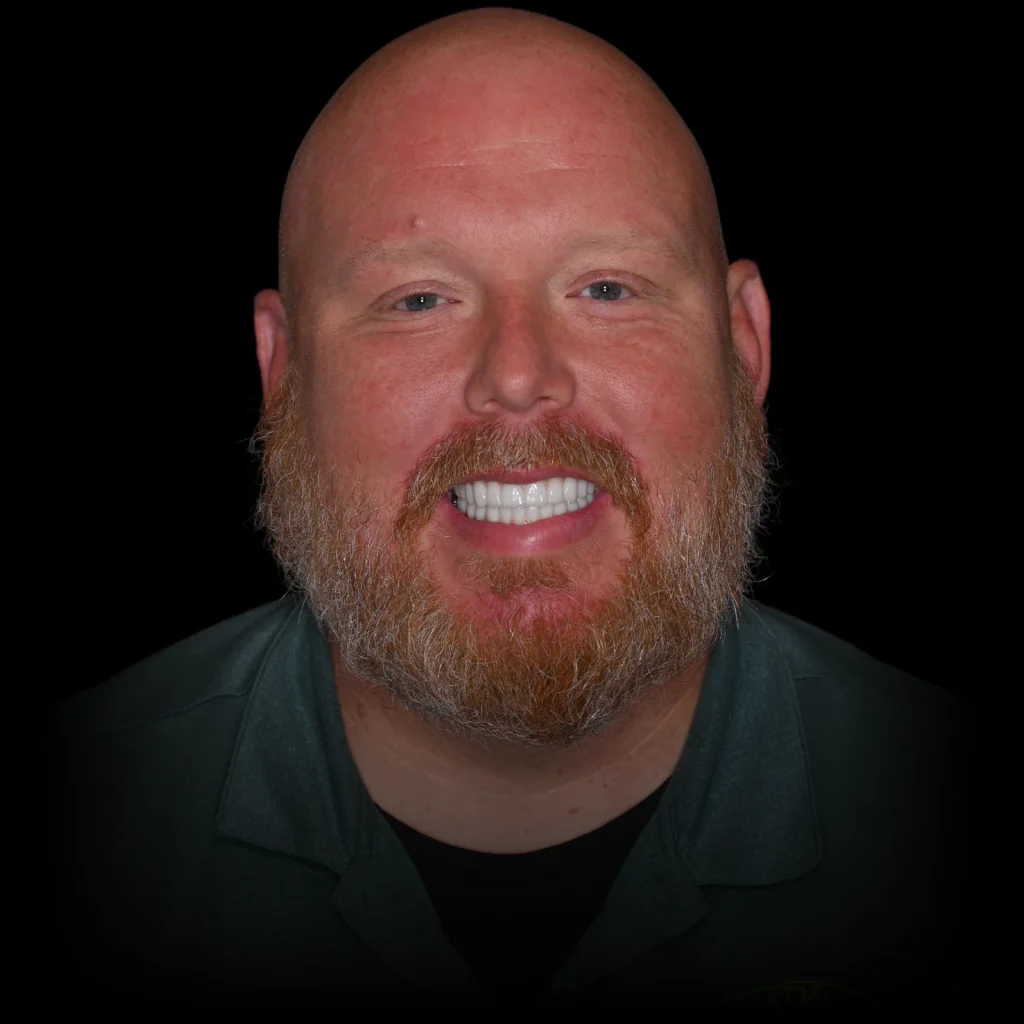 Patient smiling after all on 4 dental implants at PRACTICENAME